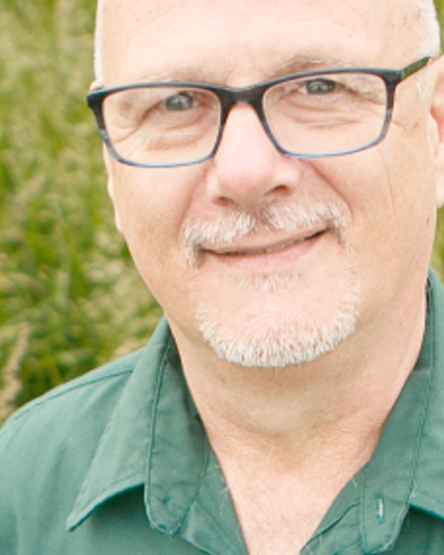 A man in a green shirt in a grass field, from Gormley's own photography