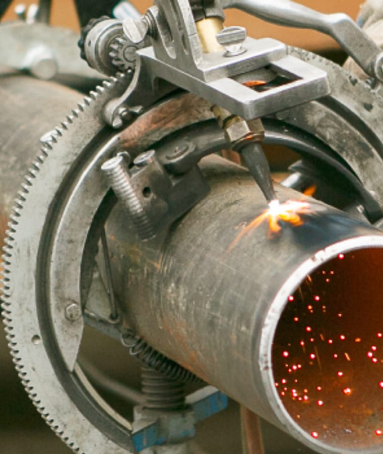 Steel pipe being cut in a shop, from Gormley's industrial photography